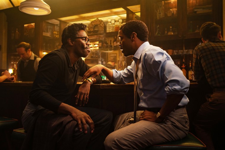 Colman Domingo as Bayard Rustin and Johnny Ramey as Elias sit a bar during a scene in "Rustin"