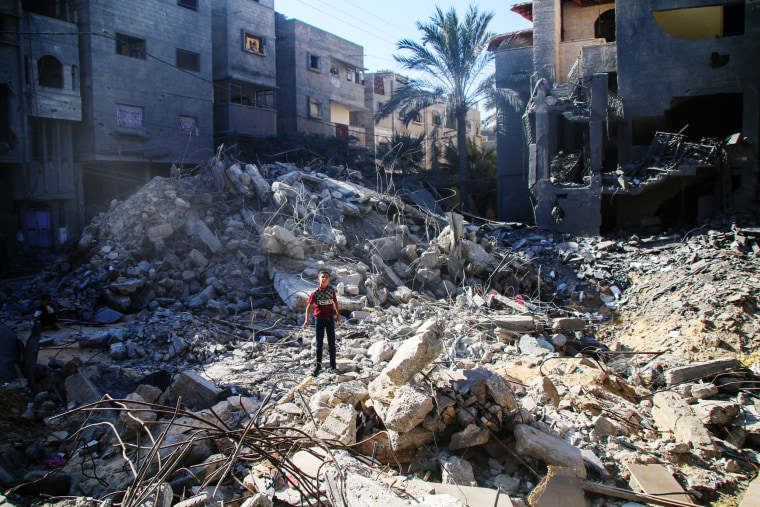 A boy stands in the rubble of a building destroyed by an Israeli airstrike in Khan Yunis in the southern Gaza Strip on Oct. 20, 2023.