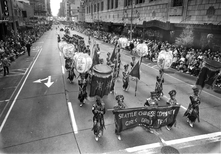 In 1952, the Seattle Chinese Community Girls Drill Team participates in the Seafair Parade for the first time in downtown Seattle.
