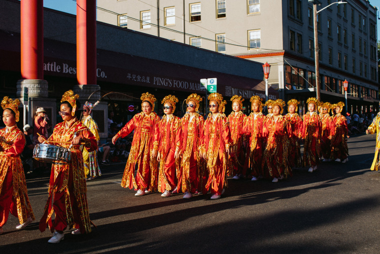 Drill Team members in high school wear sunglasses during the Chinatown Seafair Parade in 2017.