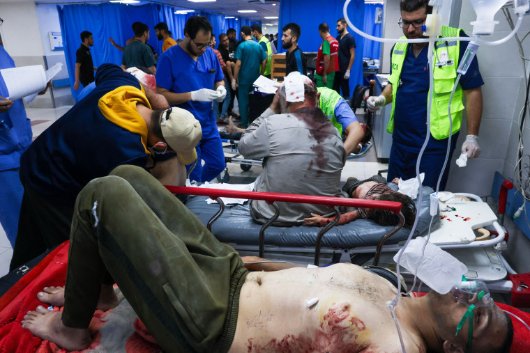 Medics attend to wounded Palestinians at Al-Shifa hospital