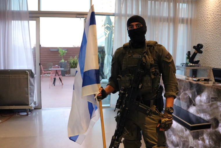 The officer walked into the room in Ashdod carrying an Israeli flag on Friday. 