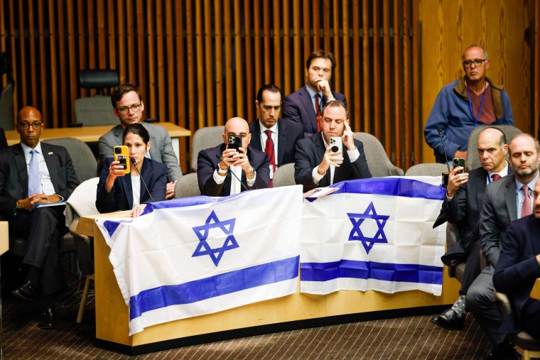 People watch footage on a screen as Israeli representatives deliver a presentation at the United Nations on Oct. 13, 2023, on the kidnappings by Hamas. 