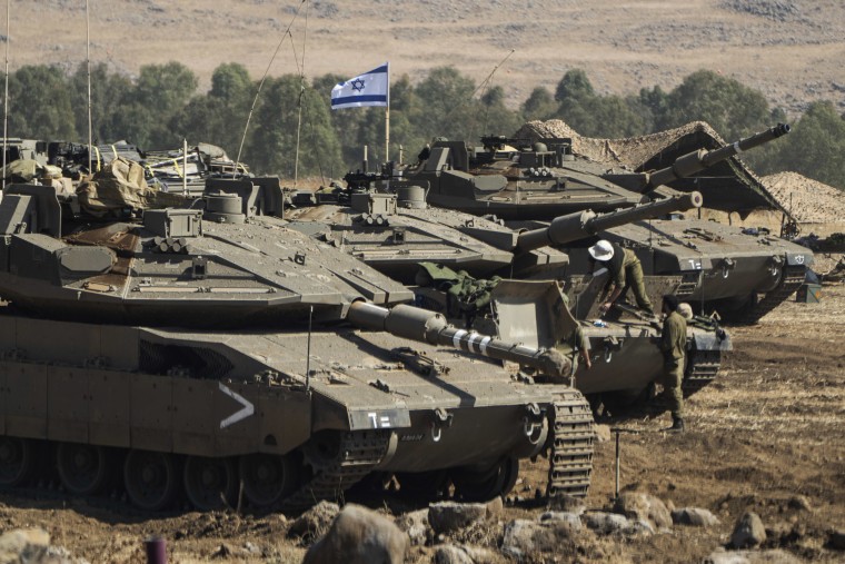 Israeli tanks are stationed near the border with Lebanon