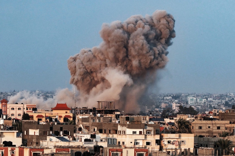 Smoke plumes rising above buildings during an Israeli strike on Rafah