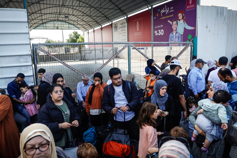Palestinians with dual citizenship gather outside Rafah border crossing with Egypt
