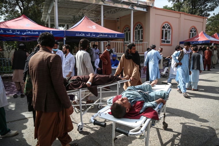 Doctors and paramedics treat the injured earthquake survivors in front of the Herat Regional Specialized Hospital
