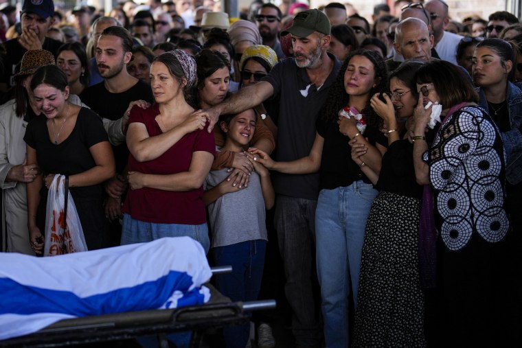 Family members mourn during the funeral of Aviya Genut at Pardes Haim cemetery in Kfar Saba, Israel.