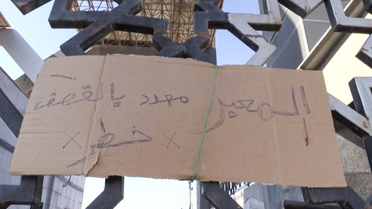 A sign in Arabic reads "Danger the crossing is threatened by bombing" at the Rafah border crossing between Gaza and Egypt.