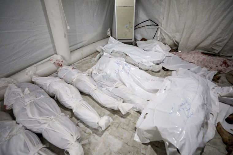 The bodies of the dead from a bombing at the Al-Ahli hospital in central Gaza lie at Al-Shifa hospital.