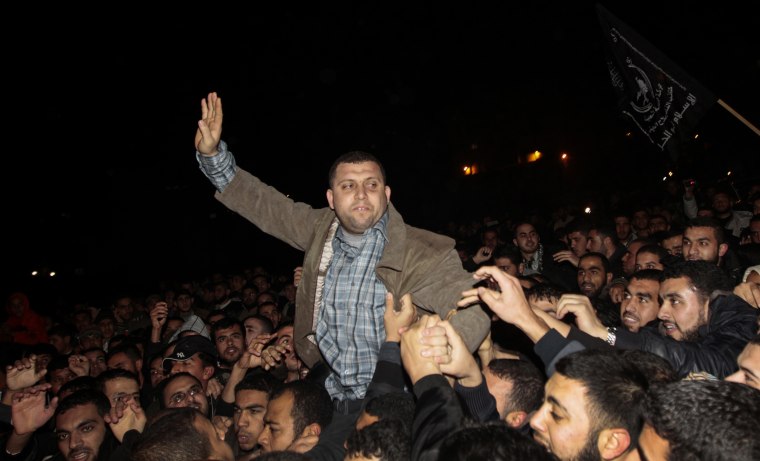 Ayman Nofal, a prominent member of Hamas' military wing Al-Qassam, waves to his supporters in Gaza.