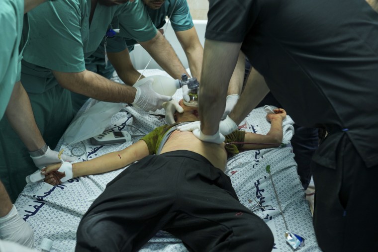 Medical workers treated a child, wounded in an Israeli airstrike, in a hospital in Deir al-Balah, southern Gaza.