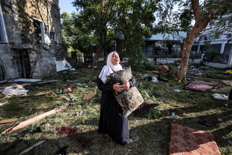 A woman cries in the garden of Al-Ahli hospital, after it was hit, in Gaza City on Oct. 18, 2023.