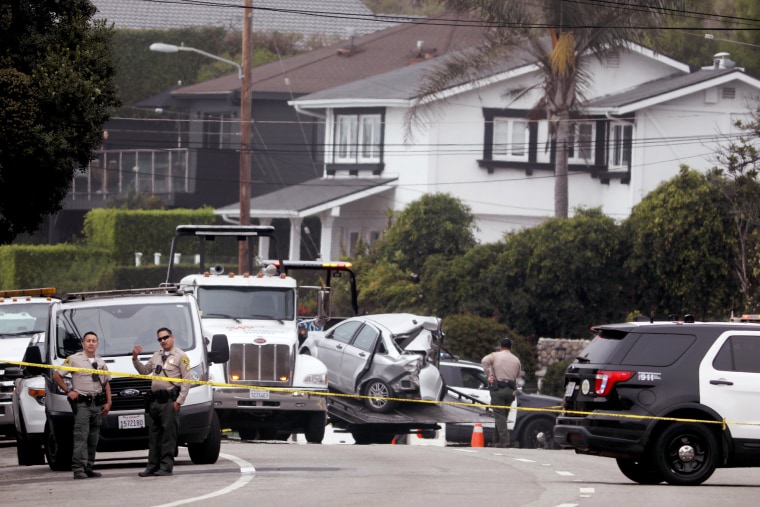 Sheriff deputies monitor the scene where four women were killed in a multi-vehicle crash in Malibu