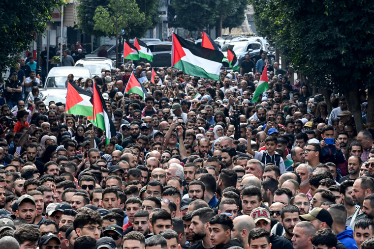 People protest in Ramallah, in the occupied West Bank, on Oct. 18, 2023.