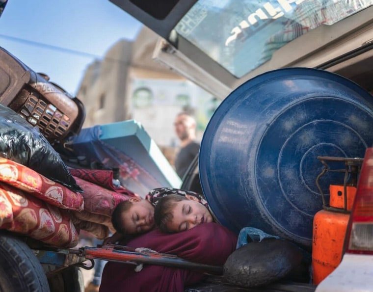 Children sleep in the back of a van in Rafah on Monday.