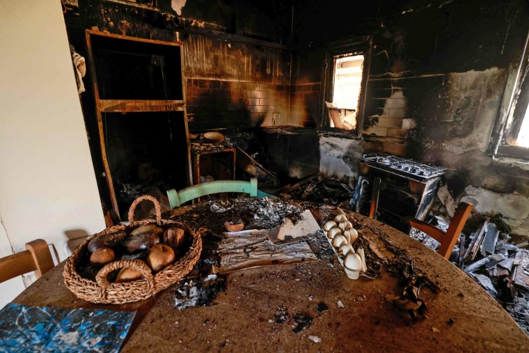 A picture taken during a media tour organized by the Israeli military shows food on a table inside a burned house in the kibbutz Nir Oz along the border with the Gaza Strip on Oct. 19, 2023. The kibbutz was attacked on Oct. 7 by Hamas militants. 