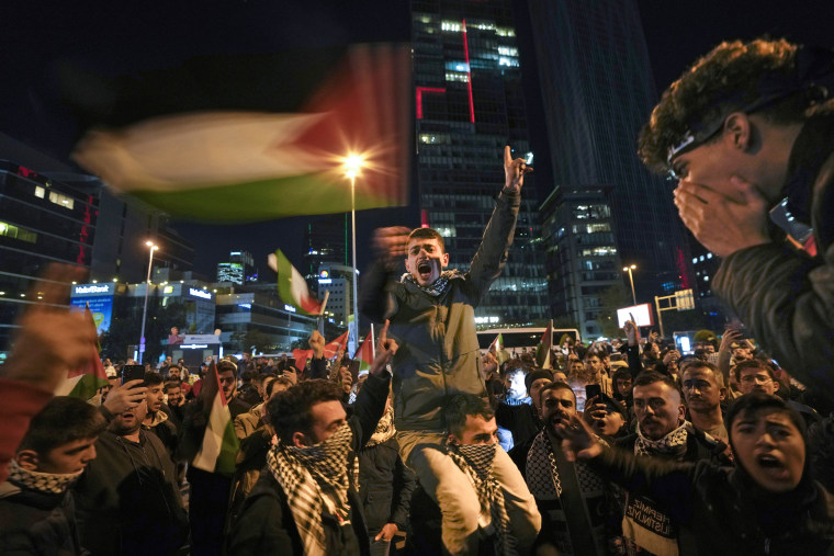 Protesters gather outside the Israeli consulate to show solidarity with Palestinians on Oct. 18, 2023, in Istanbul.