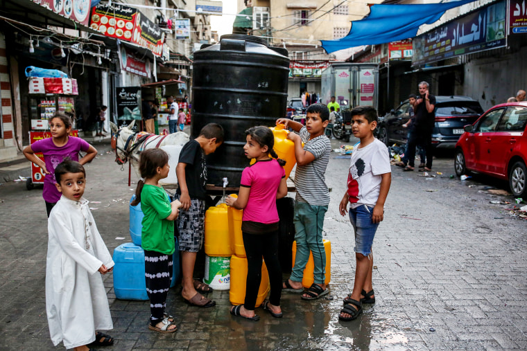 Children at a communal water distribution point in Khan Younis, in southern Gaza on Oct. 17.