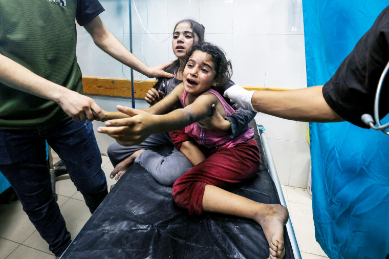 Injured children react as they receive treatment in the Nasser hospital in Khan Yunis in the southern of Gaza Strip on Oct. 17.