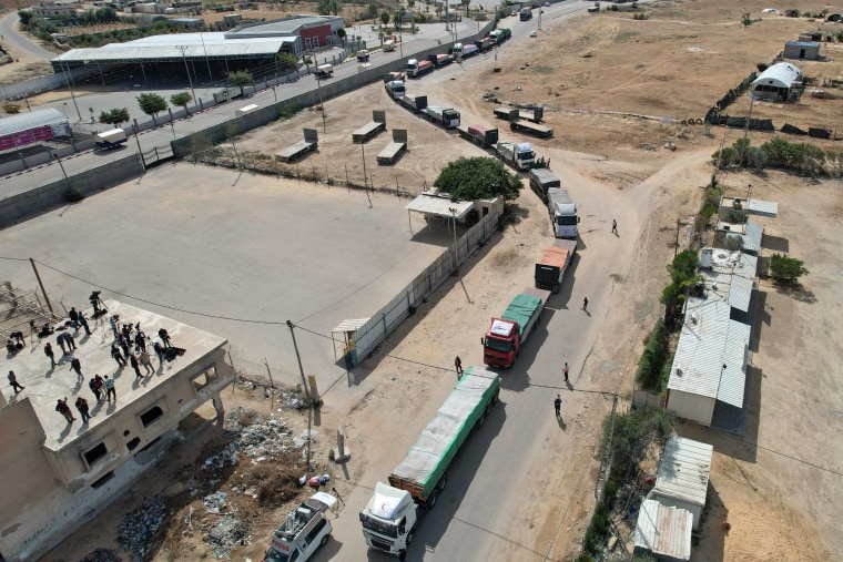 A convoy of trucks carrying humanitarian aid enters the Gaza Strip from Egypt via the Rafah border crossing on Oct. 21, 2023. 