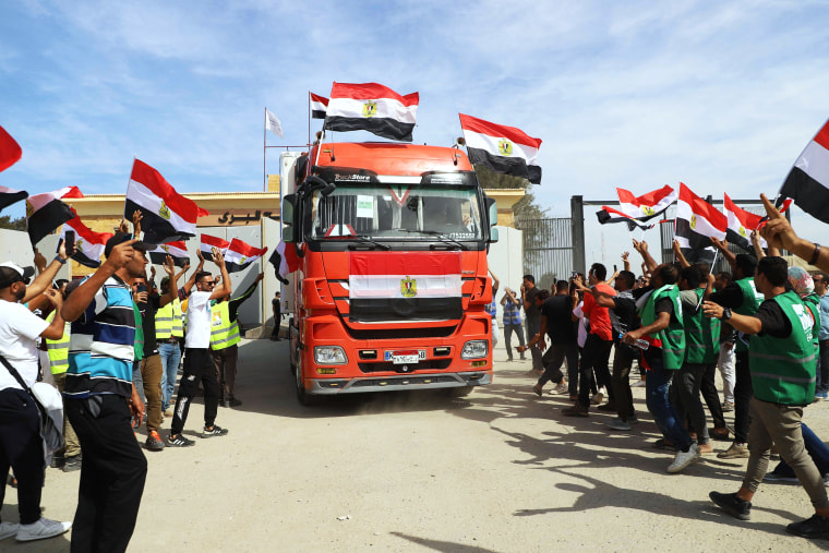 Egyptian aid workers celebrate as an aid truck returns to Egypt through the Rafah border crossing