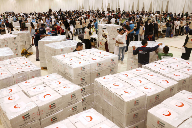 The interior of a donation center filled with volunteers and boxes