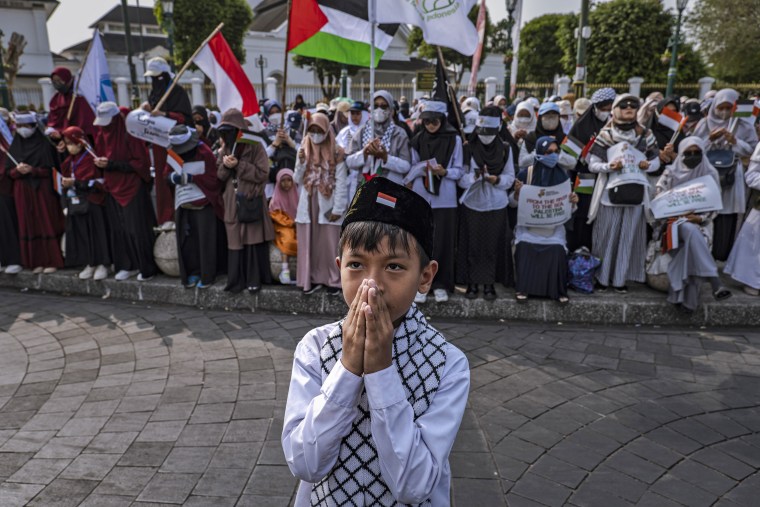 An Indonesian child prays at a rally in support of Palestinians after Friday prayers on Oct. 13, 2023 in Yogyakarta, Indonesia. 