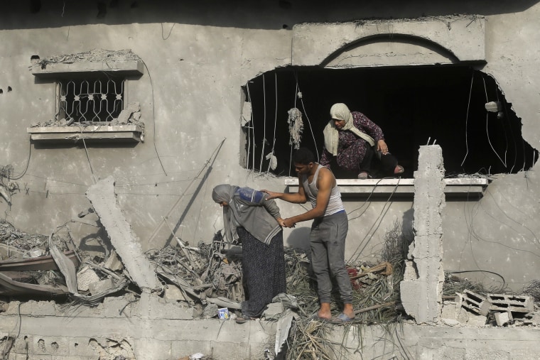 Palestinians evacuate a building damaged in the Israeli bombardment of the Gaza Strip in Rafah on Sunday, Oct. 22, 2023. 