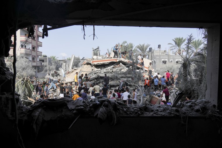 Palestinians look for survivors after the Israeli bombardment in Deir Al-Balah, Gaza.