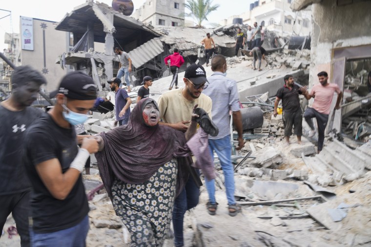 Palestinians evacuate survivors after the Israeli bombardment in Deir Al-Balah, Gaza.