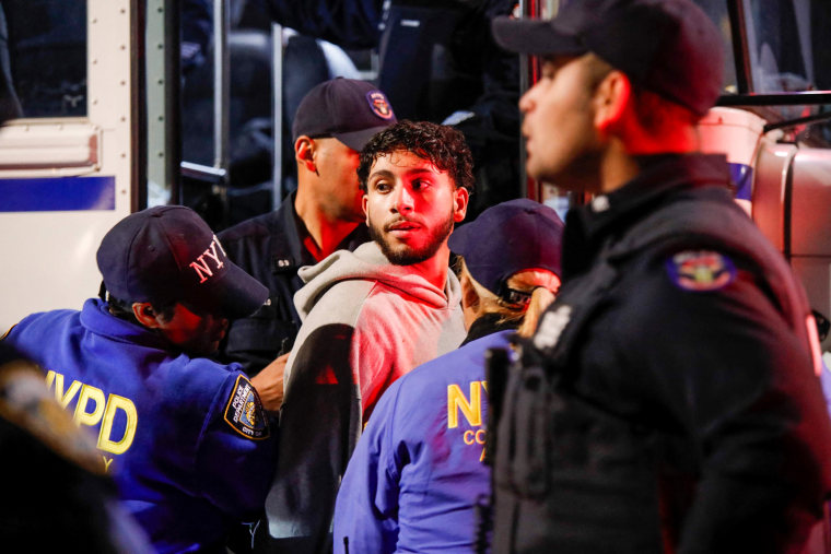 Police arrest a man at a rally in support of the Palestinians in Brooklyn, N.Y.