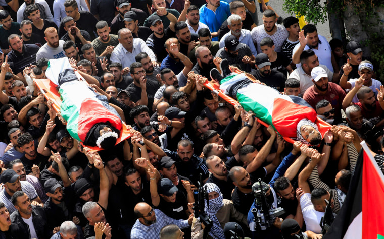 Mourners carry the bodies two Palestinian men killed in the Israeli occupied West Bank.
