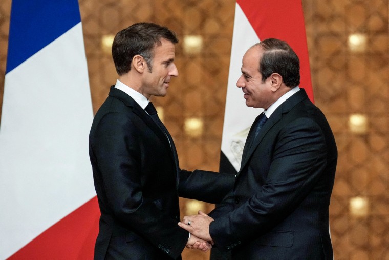 French President Emmanuel Macron and Egyptian President Abdel-Fattah al-Sisi shake hands
