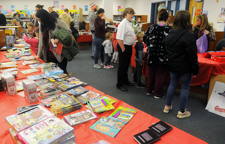 Students and parents shop for books at a Scholastic book fair in Ashland, Ohio in 2022.
