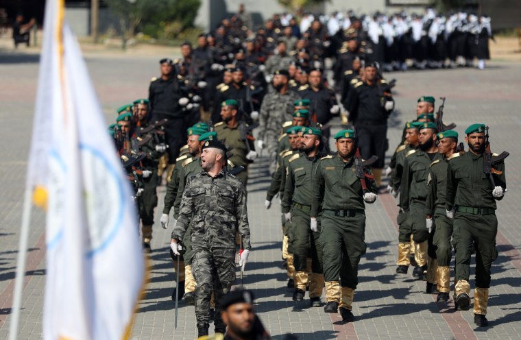 Members of the Hamas security march in a military parade during a graduation ceremony 