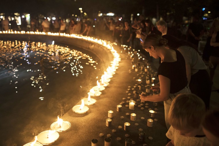 People light candles for people who were kidnapped and in memory for people killed
