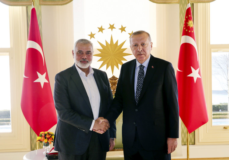 Turkish President Recep Tayyip Erdogan, right, shakes hands with Hamas movement chief Ismail Haniyeh in Istanbul.