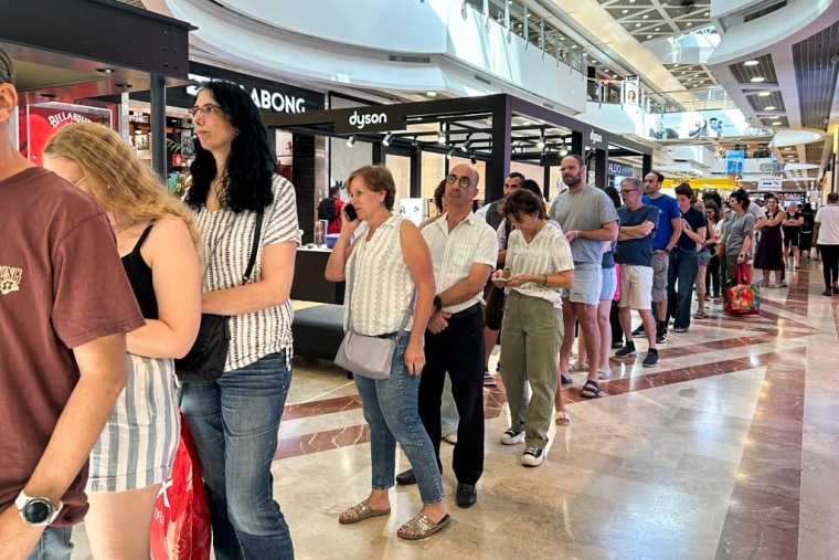 Shoppers line up at a stall selling fruit and vegetables from farmers in Israel's south at Tel Aviv's central Azrieli Mall.