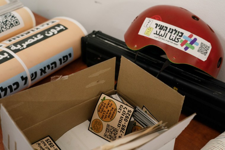 Members of the Arab-Jewish Partnership Guard in Tel-Aviv-Jaffa prepare to put up anti war posters in Jaffa, Israel.