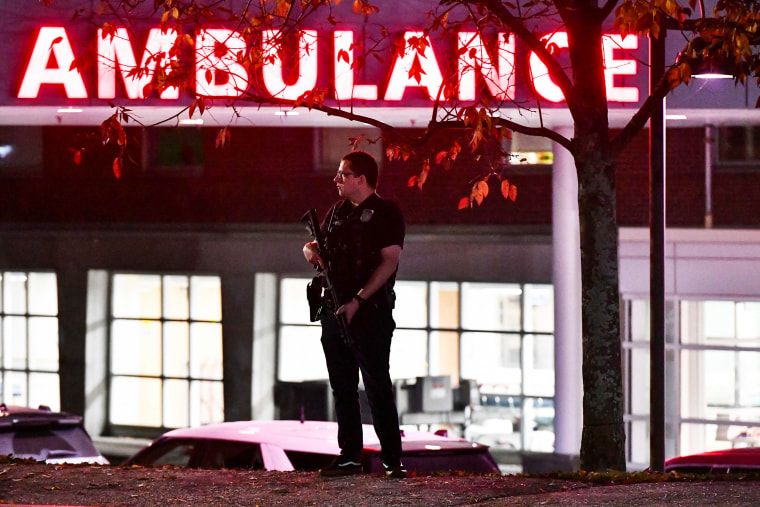 A police officer guards the ambulance entrance to the Central Maine Medical Center in Lewiston, Maine.