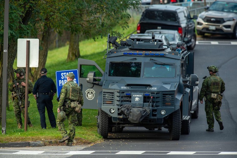 Law enforcement officers gather outside Lewiston High School, Maine on Oct. 26, 2023.