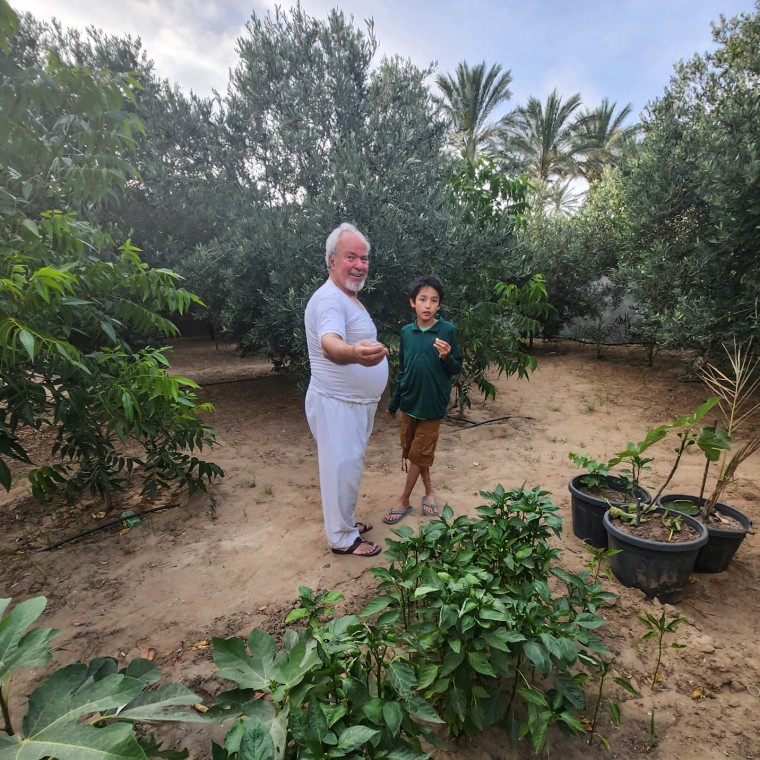 Hamed Alhayek shows his grandson Khaled Alhayek parts of their garden in their home in Gaza City's "Al Tofaha" neighborhood this past summer.