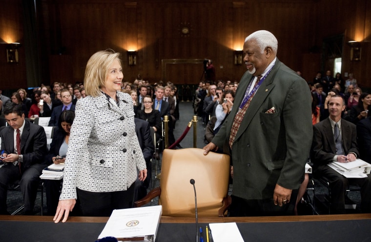 Bertie Bowman, hearing coordinator for the Senate Foreign Relations Committee, escorts Secretary of State Hillary Clinton to her seat for the Senate Foreign Relations Committee hearing on March 2, 2011.