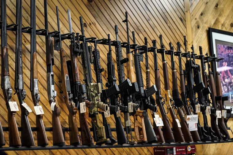 Various guns are displayed at a store in Auburn, Maine.