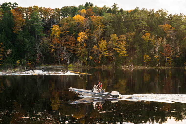 Law enforcement officers travel on the Androscoggin River as the search continues in the aftermath of a mass shooting, in Lisbon Falls, Maine,