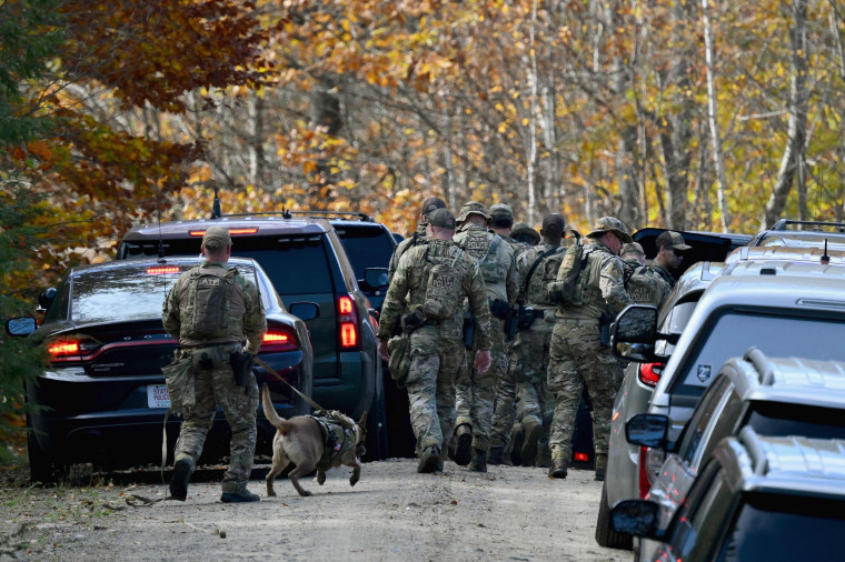 Law enforcement officials search an area near Monmouth, Maine, on Oct. 27, 2023. 
