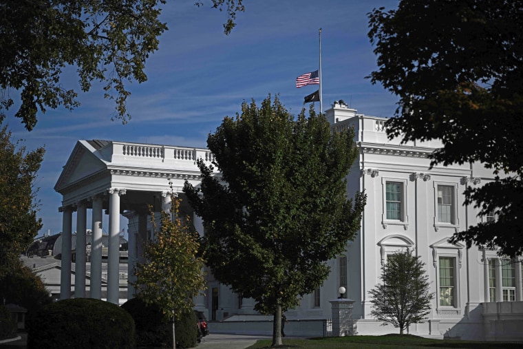 The U.S. flag flies at half-staff at the White House on Oct. 26, 2023 after a gunman killed 18 people in Lewiston, Maine. 