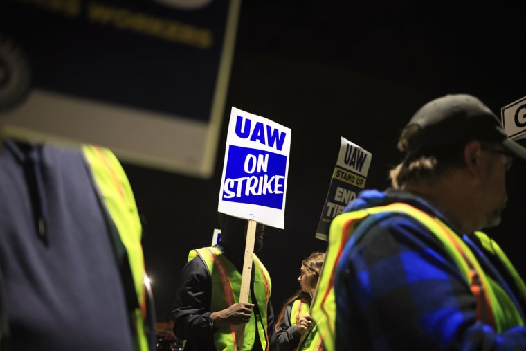 Factory workers and UAW union members picket outside the Ford Motor Co. Kentucky Truck Plant 