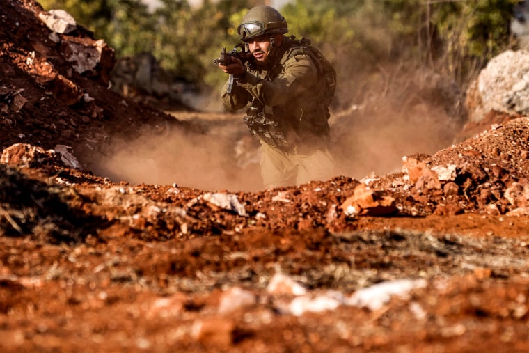 An Israeli army soldier advances during a drill at a position in near the border with Lebanon.